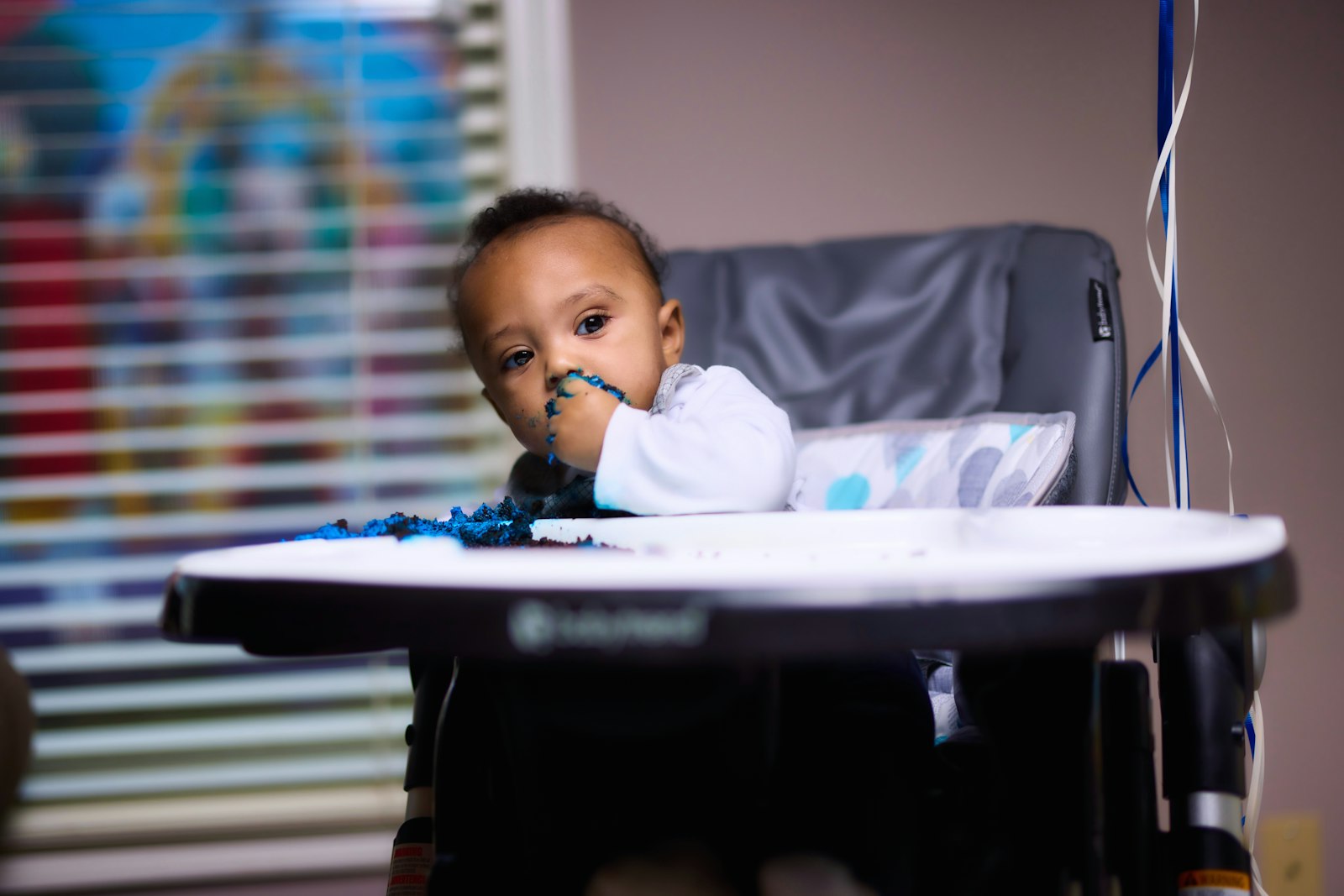 Baby sitting in a high chair at feeding time