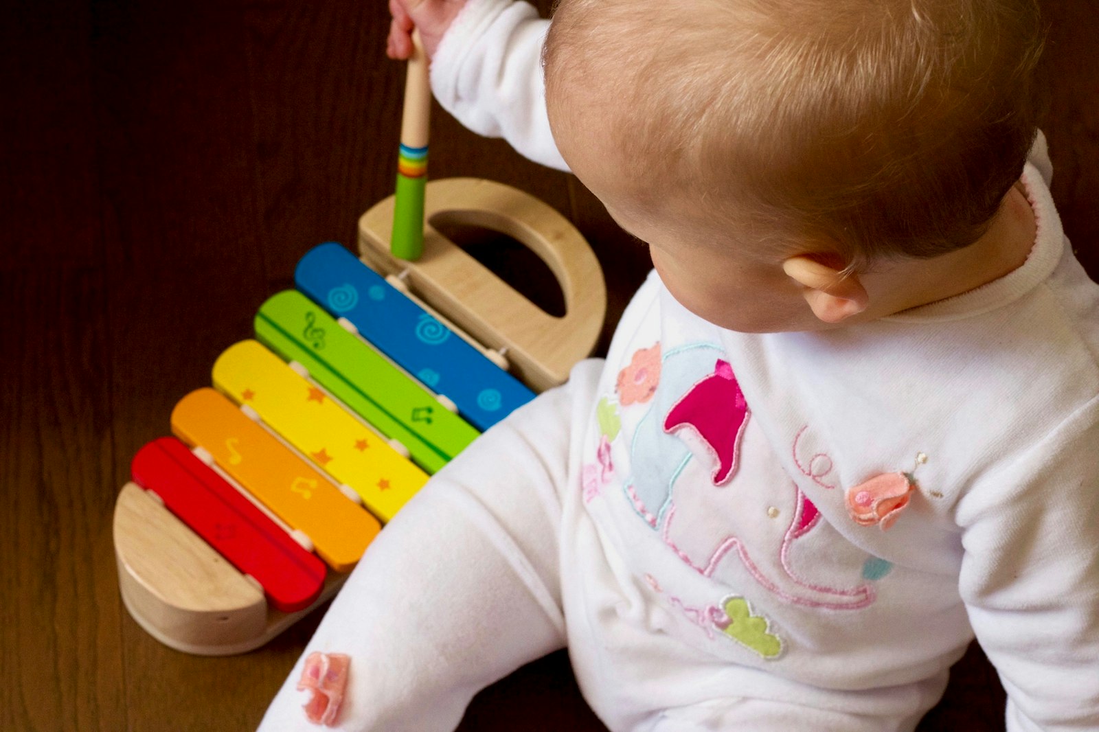 Baby playing with a colorful toy